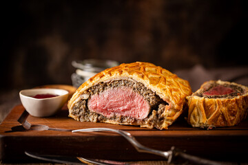 Perfect homemade juicy Beef Wellington, tenderloin dish on rustic wooden table