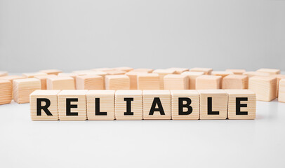Word RELIABLE made with wood building blocks