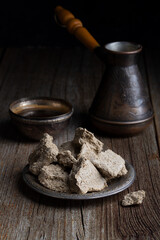 Fototapeta premium Vegetable-based halva sweet prepared from seeds on wooden background