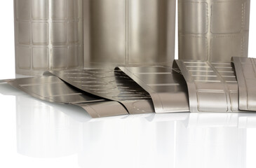 Different shapes of flexible die for die cutting on rotary, flexographic or in-line press printing machine used for label manufacturing isolated on white background with shadow reflection. Rotary dies