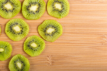 Top view of kiwi slices on wood.