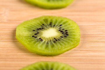 Close-up of a kiwifruit on a bamboo table