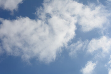 Feather clouds against blue sky in spring. Abstract background, copy space