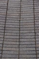 High angle view of a brick pattern of the drainage in the asphalt of a parking lot 