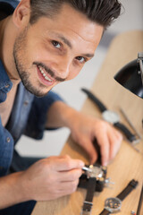 watchmaker fixing the watch movement