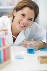 portrait of a female scientist preparing a microscope slide