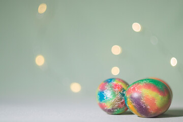 Multicolored Easter eggs on a bokeh background. Easter postcard.
