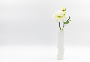 White flower in white vase