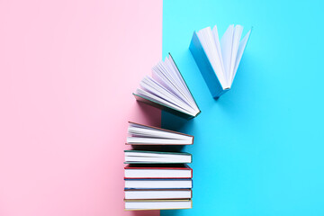 Stack of books on color background