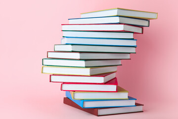 Stack of books on color background