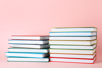 Stacks of books on color background