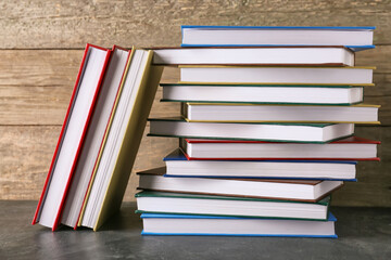 Fototapeta premium Stacks of books on wooden background