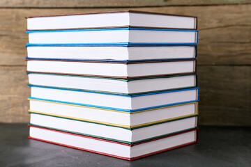 Stack of books on wooden background