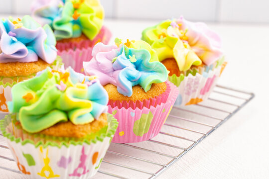 Pastel Rainbow Frosted Easter Cupcakes  on a Kitchen Counter