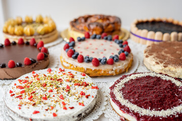 selection of cheesecakes, profiterole, carrot cake, tartlet, fruit cakes for mothersday, valentines day on white background