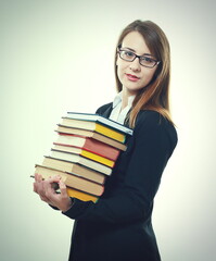 student holds pile of books