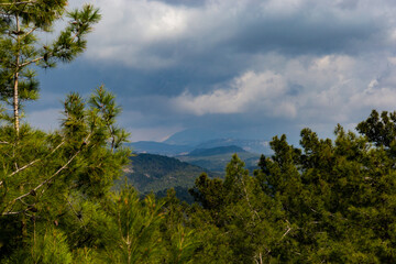 Summer landscape. Blue sky with clouds over the mountain ridge in the distance.
