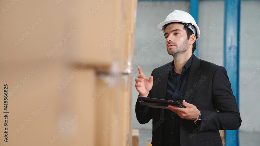 Poster factory manager using tablet computer in warehouse or factory . industry and supply chain management