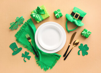 Beautiful table setting for St. Patrick's Day celebration on color background