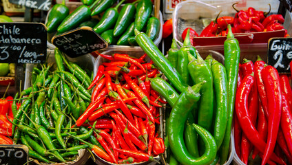 Assorted red and green chilli peppers close up on vegetables market. Organic food concept. 