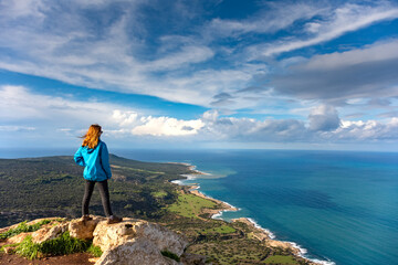 Tourist girl over Landscape of Akamas Peninsula National Park, Cyprus. Tourist resort with beaches and blue lagoons