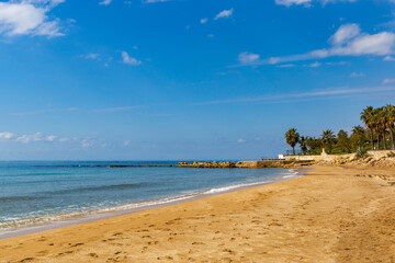 Sea beach with sand and waves. Sunny day.