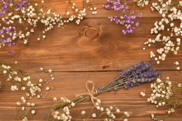 lavender bouquet and flowers on a wooden background