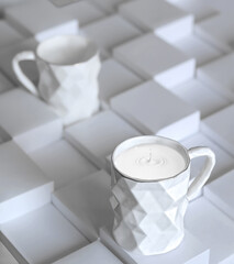 designer polygonal ceramic mug with milk and milk drops side view on white paper blocks background closeup. Selective focus