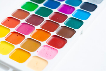 A palette of colorful watercolors on a white background