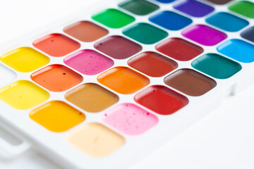 A palette of bright watercolors on a white background