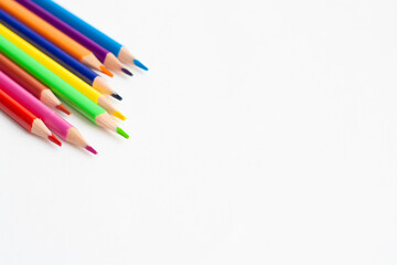 Colored pencils on a white background, copy space