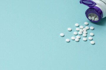 white round tablets on a blue background. The concept of medicine and Pharmacy