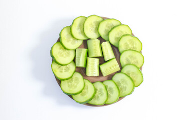 Fresh sliced cucumbers are laid out on a plate.