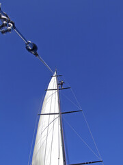 sailor at the top of the mast of sailing yacht VOLVO 60