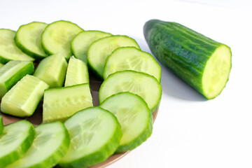 Fresh sliced cucumbers are laid out on a plate.