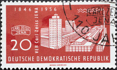 GERMANY, DDR - CIRCA 1956 : a postage stamp from Germany, GDR showing a historical picture of the building of the Carl Zeiss works, Zeiss symbol. 110 years of Carl Zeiss-Werke Jena