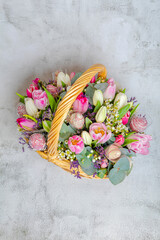 Fototapeta na wymiar Festive fruit basket with flowers, tulips. Concept, congratulations on the holiday, birthday, anniversary. There is a place for text