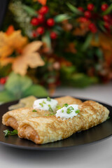 stuffed meat pancakes with herbs and cheese on a black plate