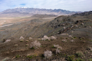 Karkas mountain range rises above desert in Isfahan province of Iran. Village of Tarq below.