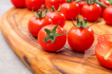 Ripe small round sweet red cherry tomatoes close up