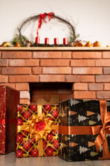 There are Christmas presents under the fireplace. The atmosphere of Christmas and the joy of gifts.