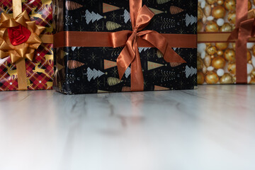 Many colorful gift boxes are lying on the floor. Christmas atmosphere.