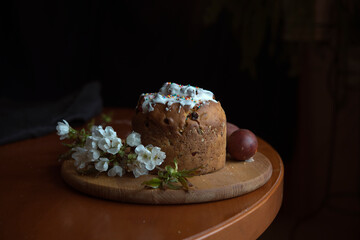 Easter, holidays and tradition concept. Easter cake. Colorful Easter eggs painted in pastel colors and blossom cherry.