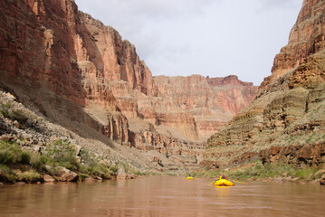 Rafts floating through the Grand Canyon.