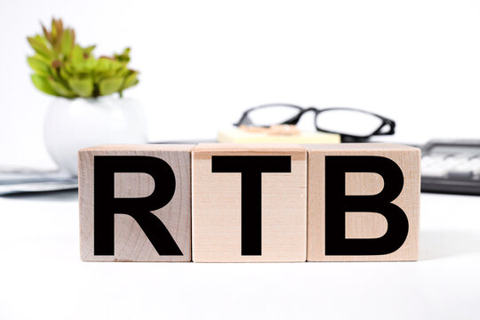 RTB as REAL TIME BIDDING. text on wood cubes. text in black letters on wood blocks