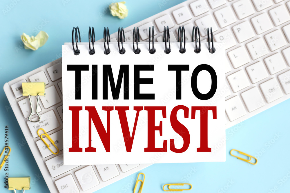 Poster text time to invest. concept in business. text on white notepad paper on white keyboard