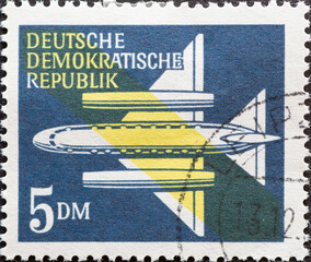 GERMANY, DDR - CIRCA 1957  : a postage stamp from Germany, GDR showing a stylized jet aircraft to...