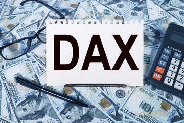 DAX . text on white paper on the background of calculator and money bills
