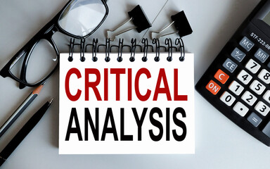 critical analysis. text on white paper on gray background