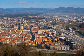 Fototapeta premium Aerial view to the city Celje in Slovenia. Red roofs, river and the bridge. Outdoor travel background.